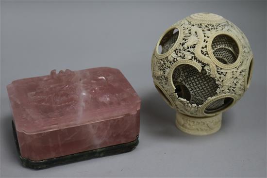 A rose quartz box and a carved ivory ball